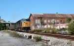CSX 4765 thunders past abandoned buildings near Garnet Street